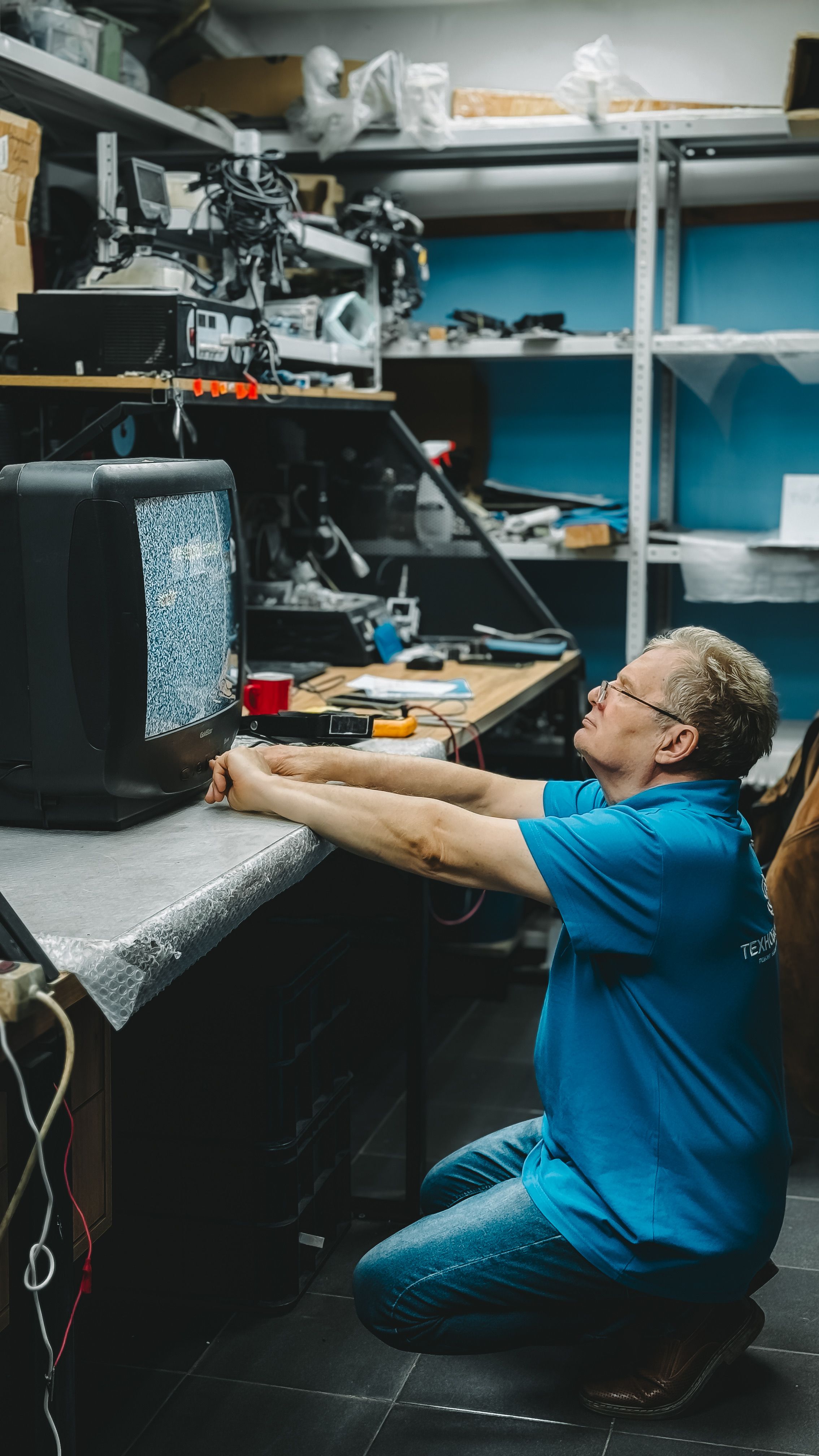 A Zibuke OnCall technician carefully repairing a television with absolute care